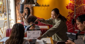 students filming scene in cafe