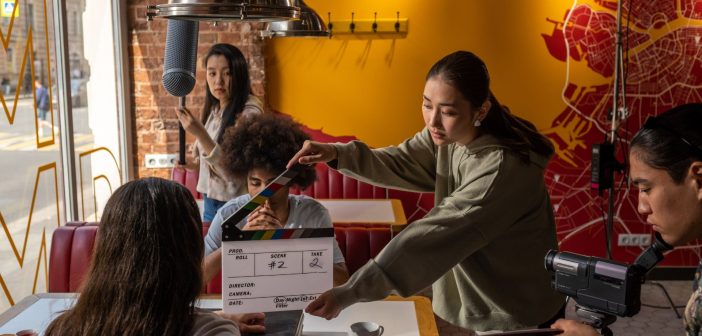 students filming scene in cafe